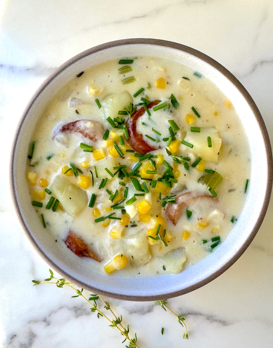 A hearty bowl of corn chowder loaded with potatoes and chicken sausage.
