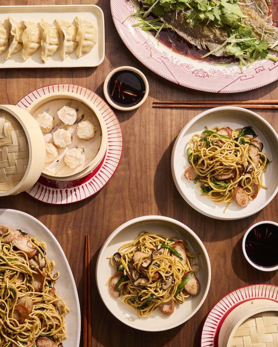 A massive family-style Lunar New Year feast with dumplings, steamed fish and longevity noodles.